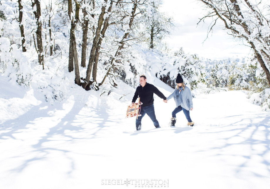 snow engagement shoot with a vintage sled as a prop