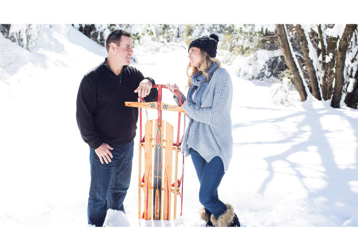 snow engagement shoot with a vintage sled as a prop