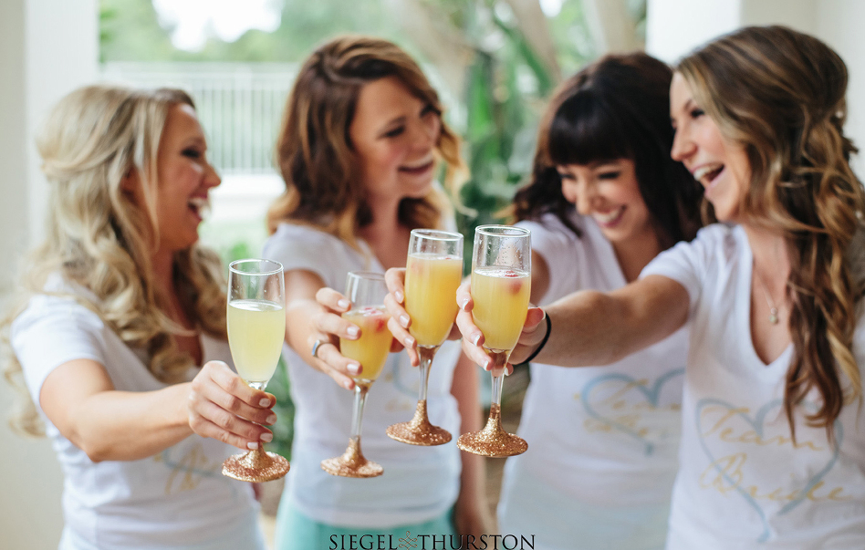 bridesmaids and glitter coated champaign glasses