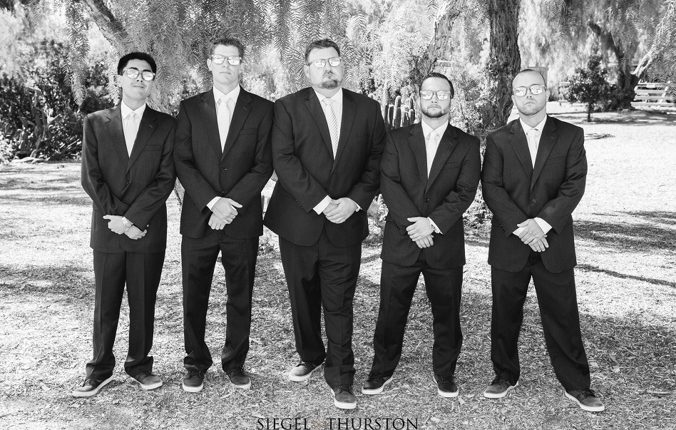 groom and his groomsmen wearing ray bans sunglasses